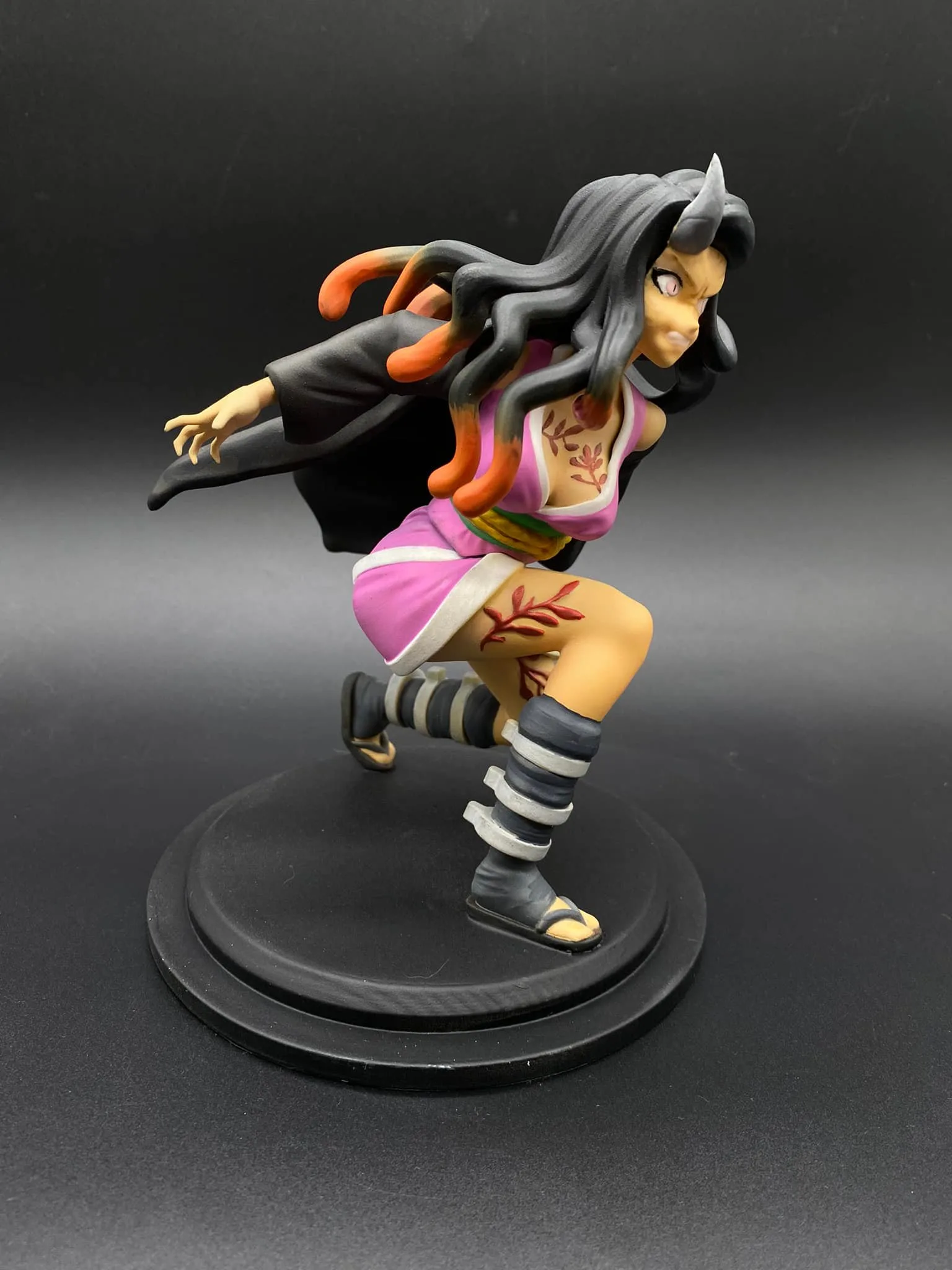 Close-up of Nezuko's face with pale pink eyes and demon features