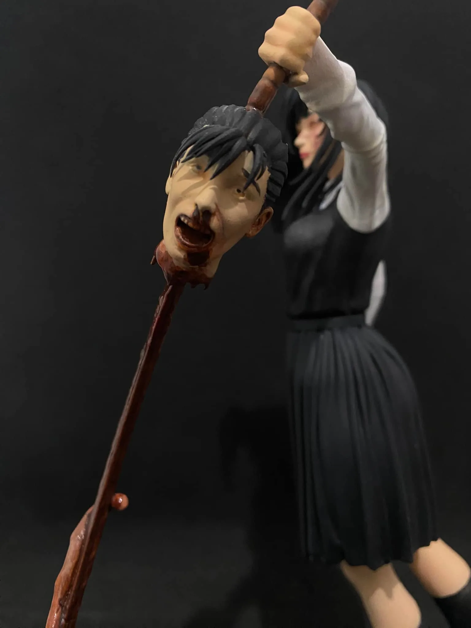Close-up of Asa's expression and Yoru's grotesque weapon design