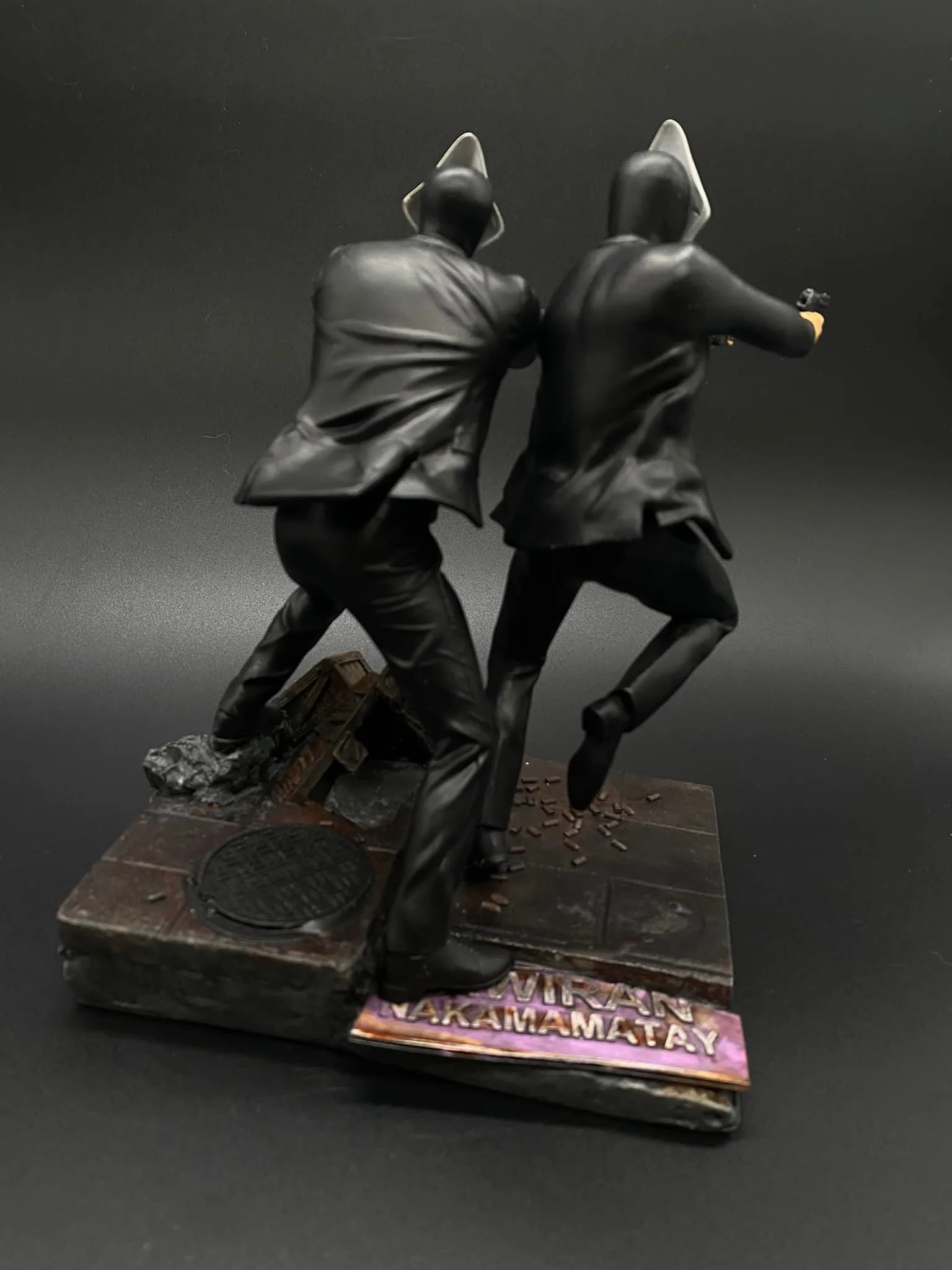 Detail shot of the dilapidated street signage on the Crispin and Basilio v2 sculpture base