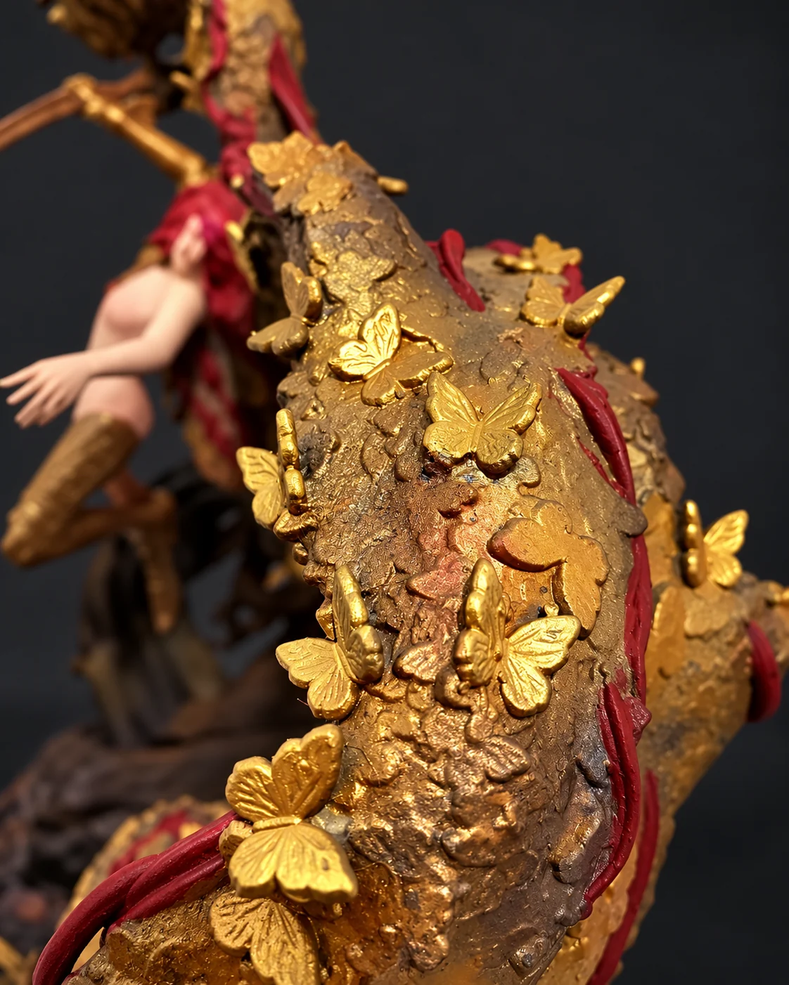 Close-up of hand-painted gold butterflies on the rot wing