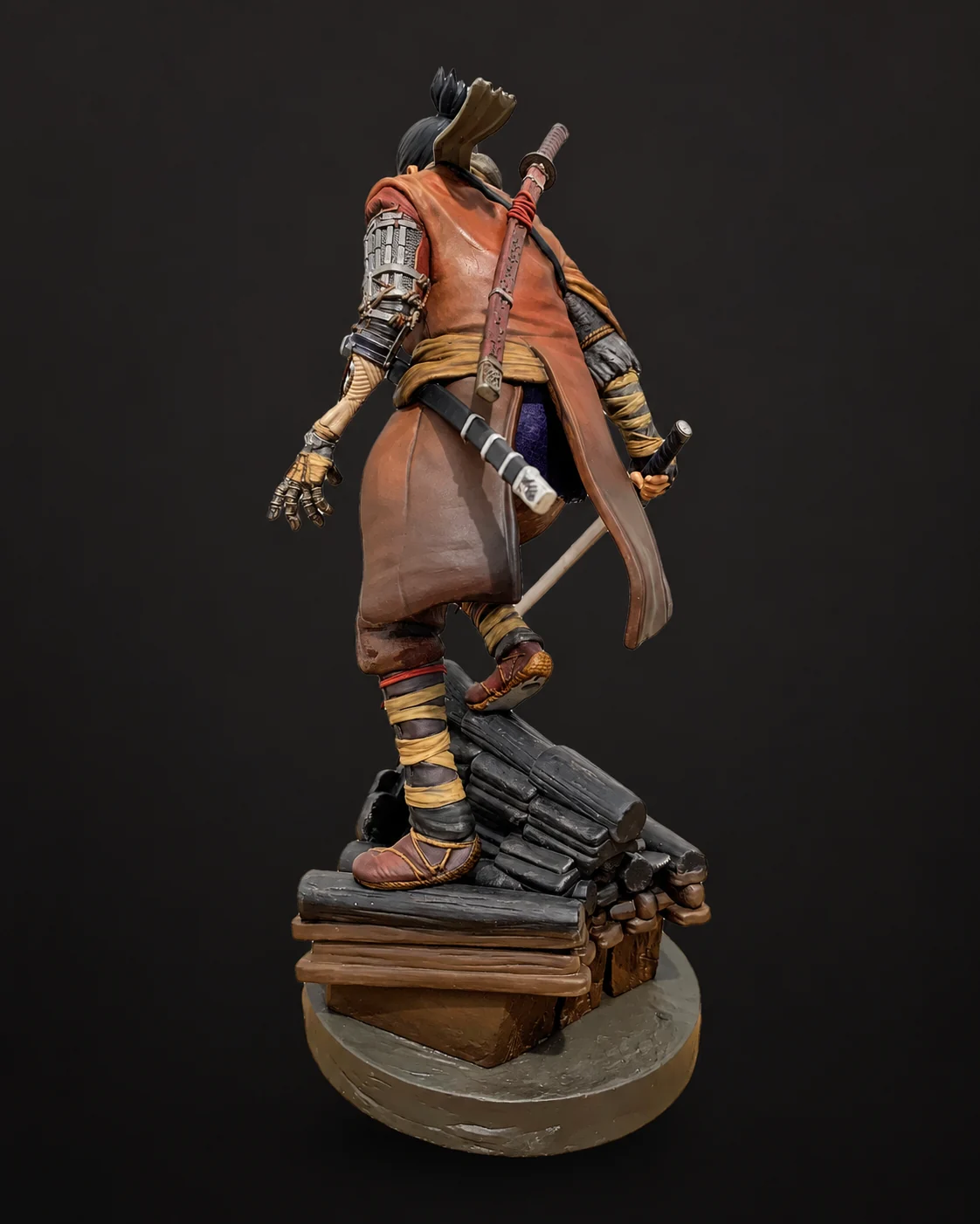 Back of the Sekiro statue showing the red haori and sheathed sword